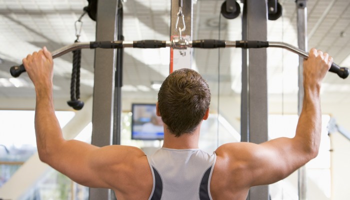 Man Weight Training At Gym