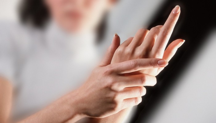 2000 --- Woman Rubbing Her Hands --- Image by © Royalty-Free/Corbis