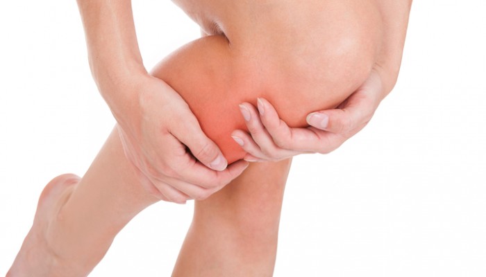 Close up of woman leg injury isolated on white background